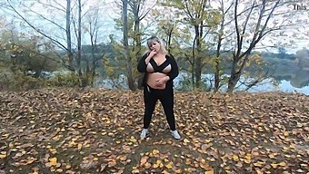 A Milf With A Beautiful Body And Large Breasts Plays In A Public Park Near A Lake